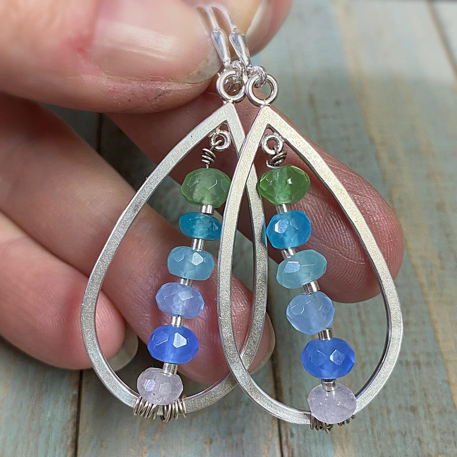 Artisan Sterling Silver teardrops with a single line of cascading blue colored quartz stones. Very unique, one of a kind. Leverback earwires