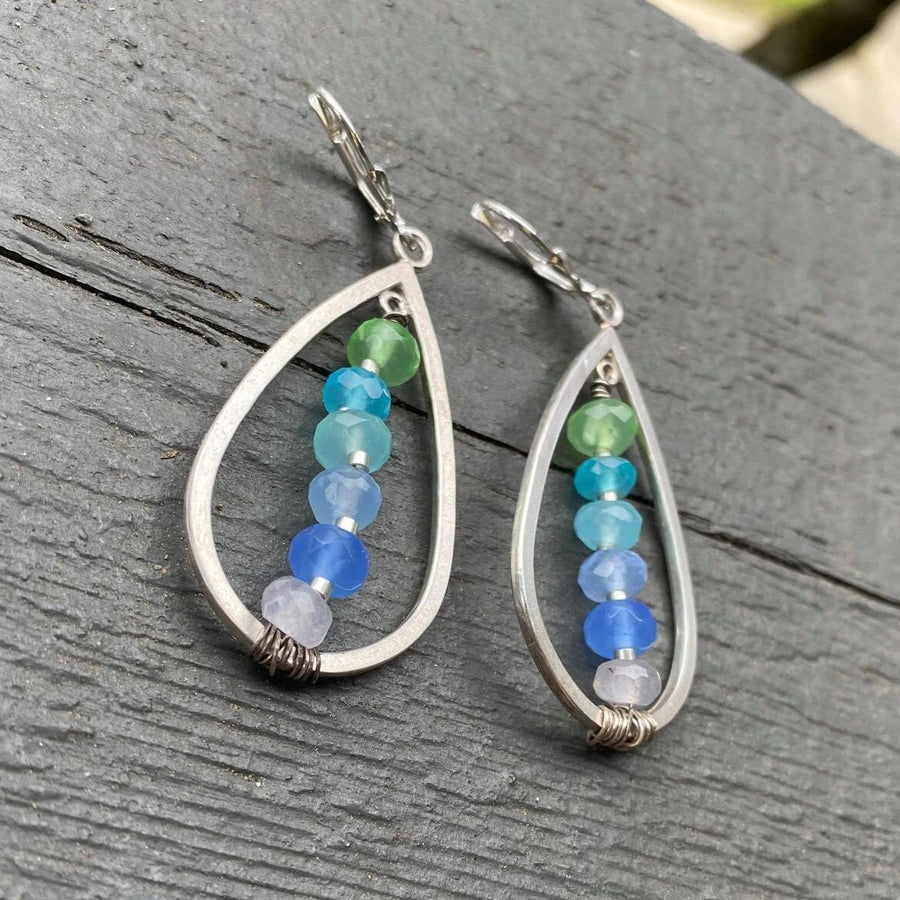 Artisan Sterling Silver teardrops with a single line of cascading blue colored quartz stones. Very unique, one of a kind. Leverback earwires